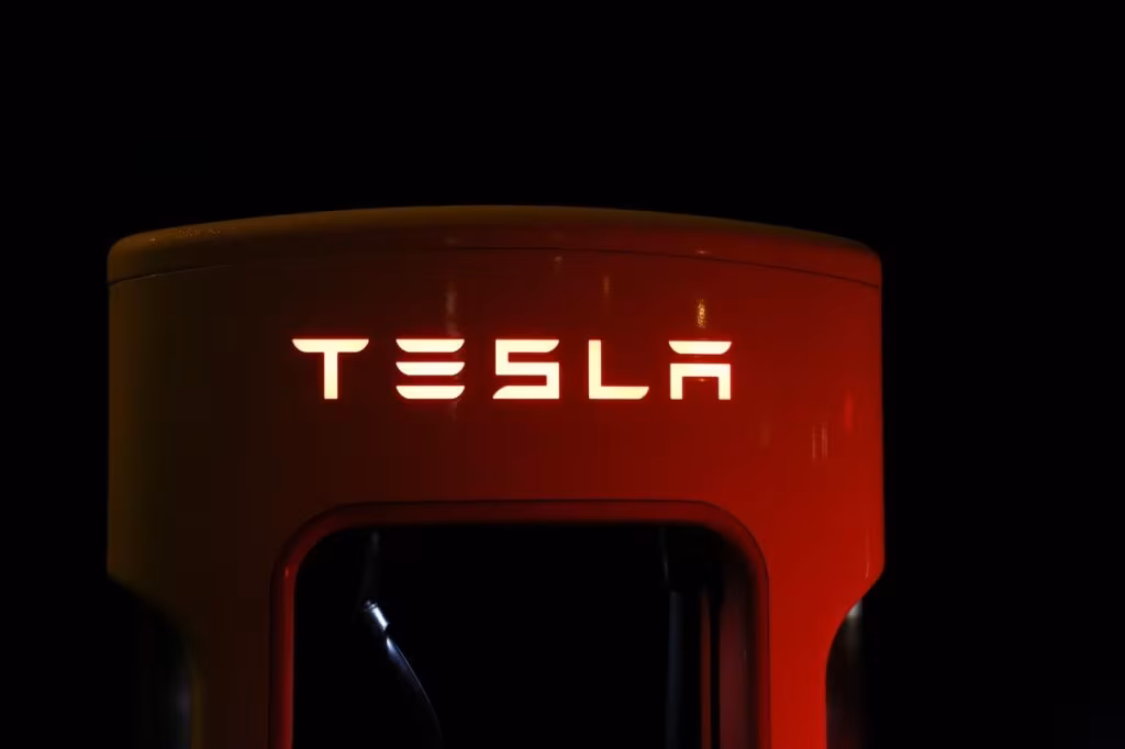 Tesla Model Y charging at a Supercharger station in a busy Chinese city, reflecting the competitive market.