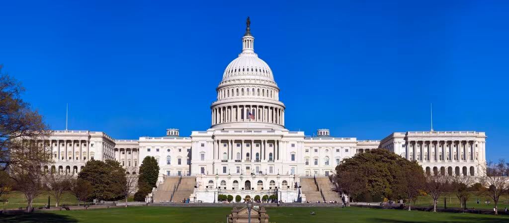 The U.S. Capitol Building under dark clouds, symbolizing the political impasse causing the shutdown.