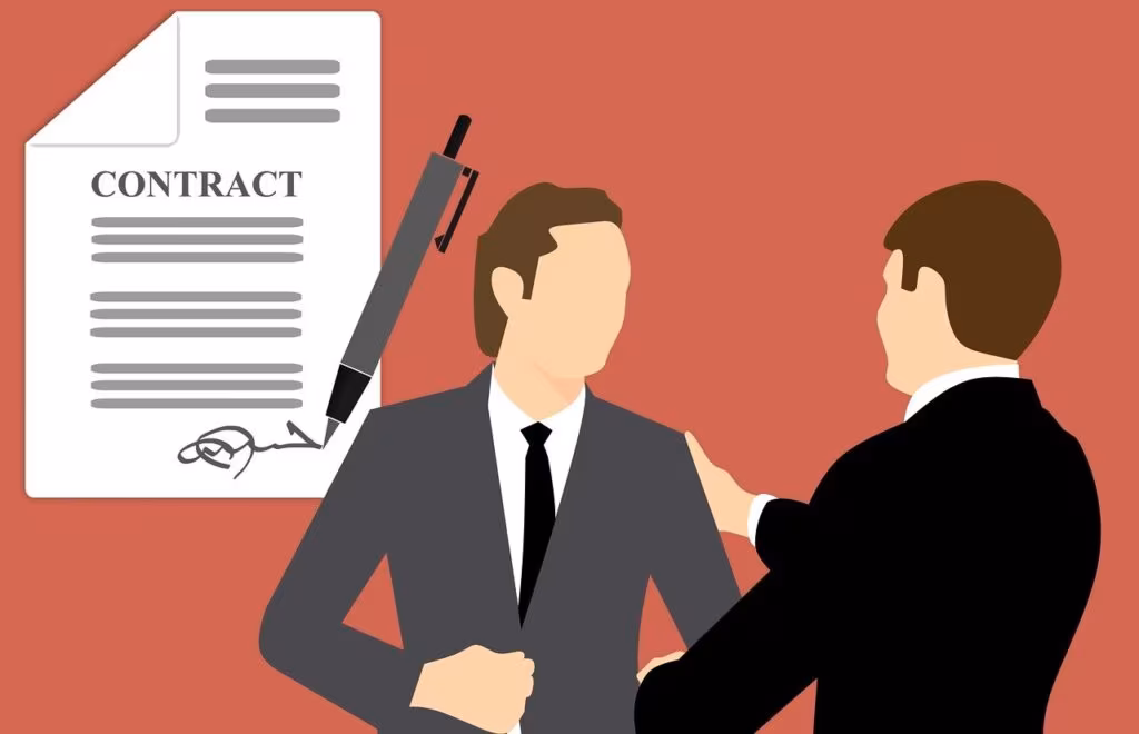 Two professionals shaking hands over a signed business contract on a modern desk.