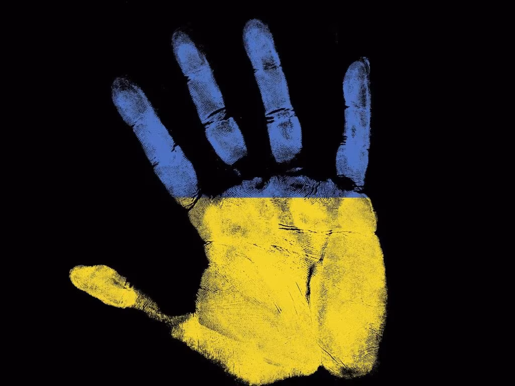 Ukrainian flag flying near a military checkpoint, symbolizing the ongoing fight for sovereignty.