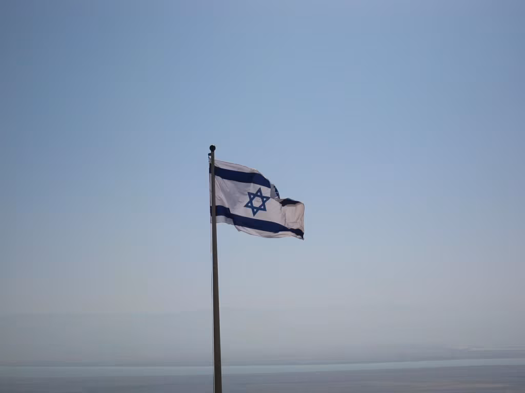 View of Jerusalem skyline with an Israeli flag, symbolizing the focus of political commentary in Israel